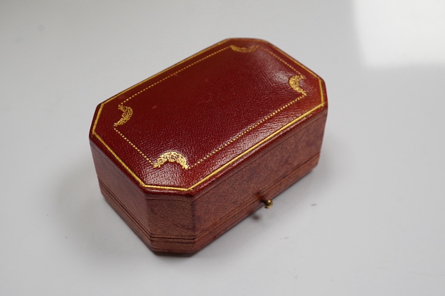 A 1930's/1940's Cartier gilt tooled leather cufflink box, of octagonal form, 83mm by 54mm. Condition - poor to fair